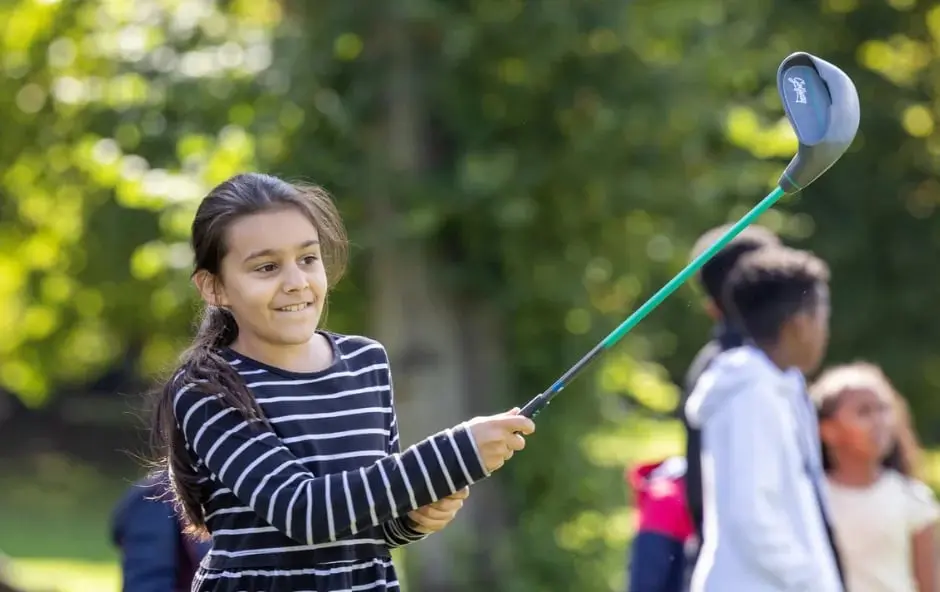 Girl hitting a golf shot