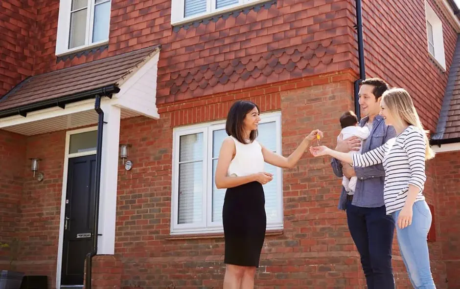 LSL couple with baby getting house keys